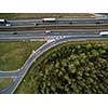 Aerial view of a highway amid fields with cars on it