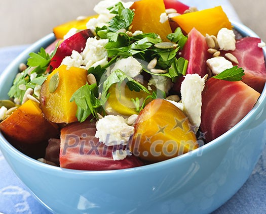 Closeup on bowl of roasted sliced red and golden beets
