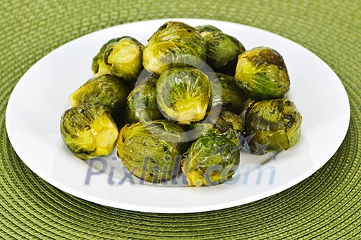 Plate of roasted green brussels sprouts on placemat