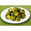 Plate of roasted green brussels sprouts on placemat