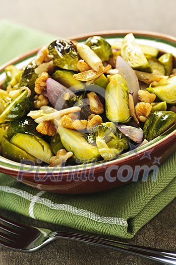 Vegetarian bowl of roasted brussels sprouts with walnuts