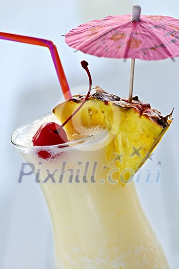 Pina colada drink in hurricane cocktail glass isolated on white background