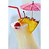 Pina colada drink in hurricane cocktail glass isolated on white background