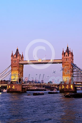 Tower bridge in London England at sunset over Thames river