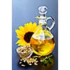 Sunflower oil bottle with raw seeds and flower