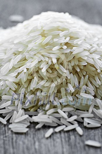 Pile of raw long grain white rice grains Pile of raw long grain white rice grains
