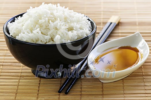 Rice bowl with soy sauce with chopsticks Rice bowl with soy sauce with chopsticks