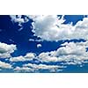 Background of blue sky with white cumulus clouds