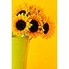 Bouquet of sunflowers in yellow metal vase