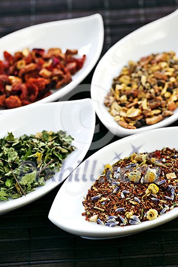 Herbal wellness dried tea in four bowls Herbal wellness dried tea in four bowls