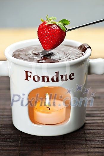 Strawberry dipped in delicious melted chocolate fondue