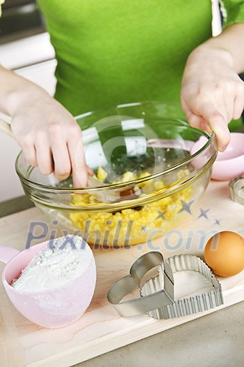 Mixing ingredients for baking cookies in glass bowl