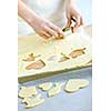 Woman using cookie cutter and baking homemade cookies