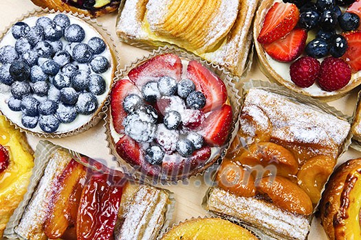 Background of assorted fresh sweet tarts and pastries from above Background of assorted fresh sweet tarts and pastries from above