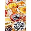 Background of assorted fresh sweet tarts and pastries