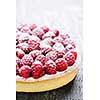 Fresh dessert fruit tart covered in raspberries