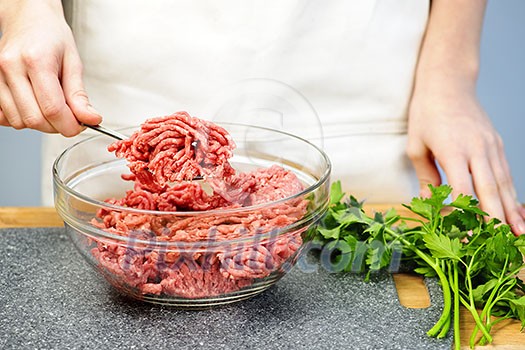 Chef cooking in kitchen with ground beef Chef cooking in kitchen with ground beef