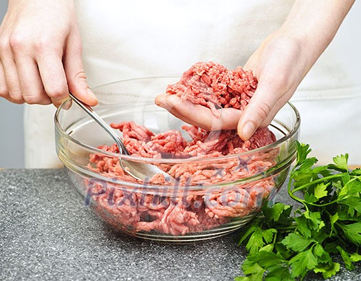 Chef cooking in kitchen with ground beef Chef cooking in kitchen with ground beef