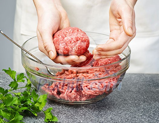 Chef making hamburgers in kitchen with ground beef Chef making hamburgers in kitchen with ground beef