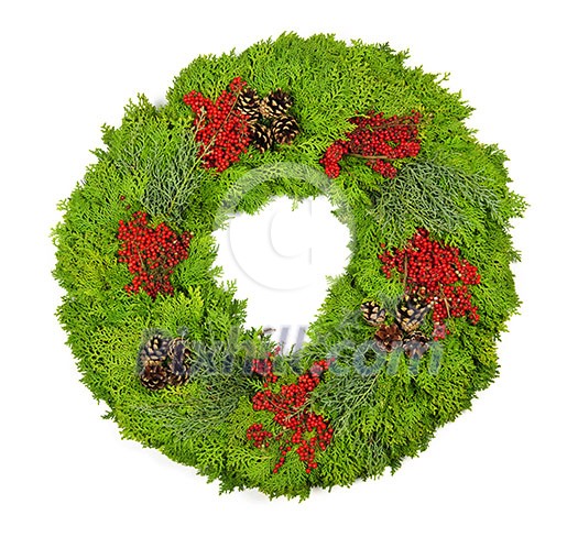 Green Christmas wreath with pine cones and berries isolated on white