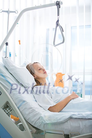 Pretty, young, female patient in a modern hospital room. Getting better fast after a surgery - pensive yet positive, thinking ahead, making plans (shallow DOF; color toned image) Pretty, young, female patient in a modern hospital room. Getting better fast after a surgery - pensive yet positive, thinking ahead, making plans (shallow DOF; color toned image)