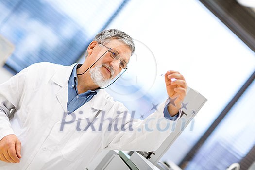 Senior male researcher carrying out scientific research in a lab (shallow DOF; color toned image) Senior male researcher carrying out scientific research in a lab (shallow DOF; color toned image)