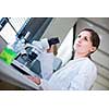 Portrait of a female chemistry student carrying out research in a chemistry lab (color toned image; shallow DOF)