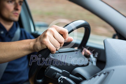 Male driver's hands driving a car on a highway (color toned image; shallow DOF) Male driver's hands driving a car on a highway (color toned image; shallow DOF)