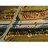 Aerial view of a highway amid fields with cars on it