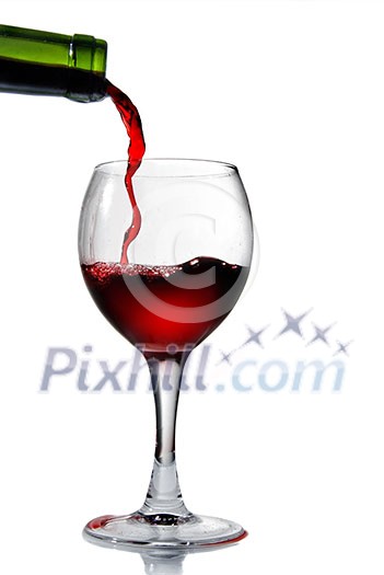 Pouring red wine in goblet isolated on white