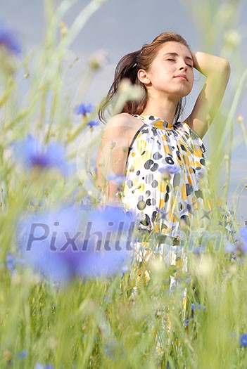 Girl posing in field of flowers
