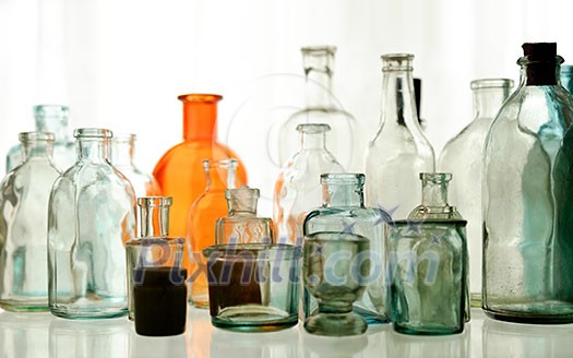 Set glass empty bottles on the shelf. Vintage glass set. Set glass empty bottles on the shelf. Vintage glass set.