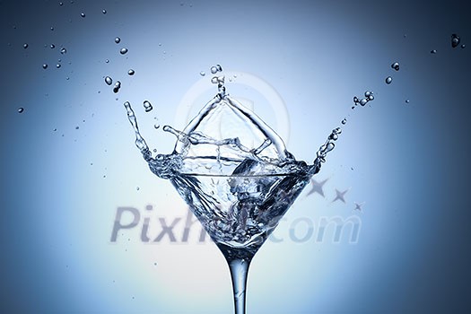 Water splash in glass with ice cubes. Water splash in glass with ice cubes.