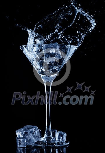 Water splash in glass with ice cubes. Water splash in glass with ice cubes.