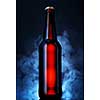 Bottle of beer on a dark background. Mysterious background with smoke.