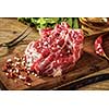 Raw beef steak with salt and herbs on wooden cutting board