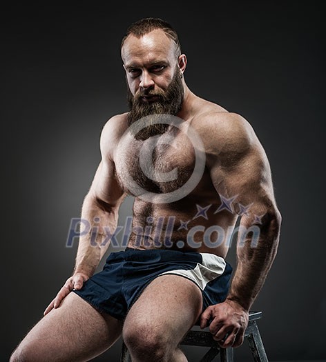 Portrait of strong bearded man with perfect abs, pecs shoulders,biceps, triceps and chest. Portrait of strong bearded man with perfect abs, pecs shoulders,biceps, triceps and chest.