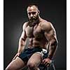 Portrait of strong bearded man with perfect abs, pecs shoulders,biceps, triceps and chest.