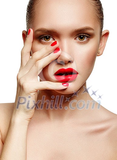 Young woman with red lips and red nails, touching her face isolated on white background