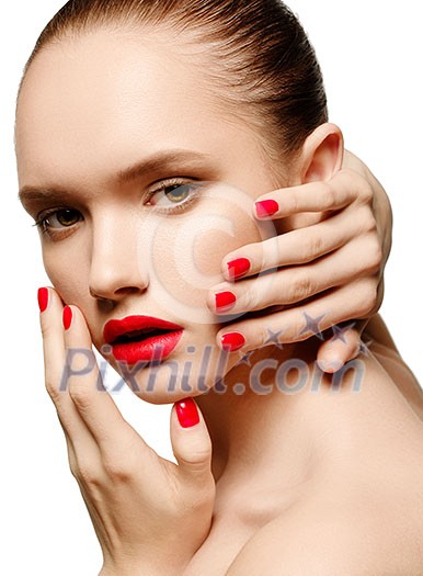 Young woman with red lips and red nails, touching her face isolated on white background Young woman with red lips and red nails, touching her face isolated on white background