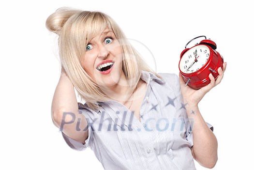 Shocked beautiful young woman with alarm clock isolated on white