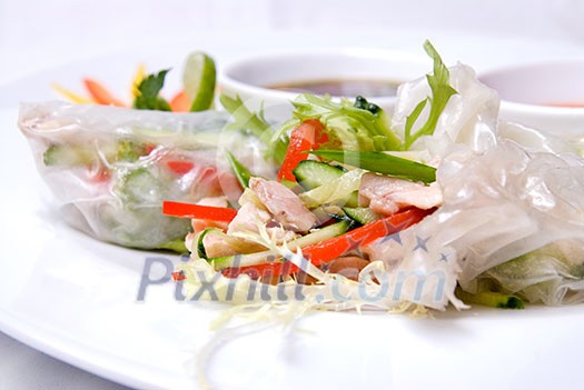 chinese rolls with vegetables on the plate chinese rolls with vegetables on the plate