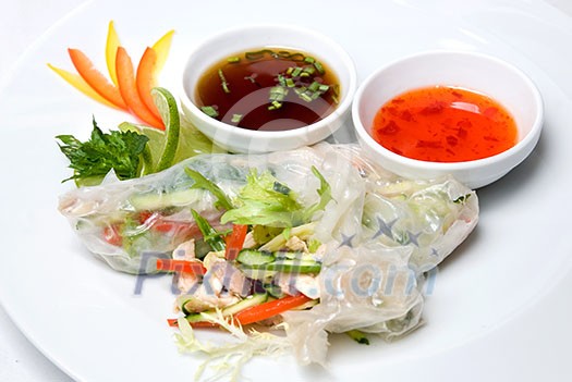 chinese rolls with vegetables on the plate chinese rolls with vegetables on the plate