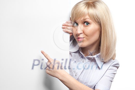 Attractive smiling woman holding white empty paper and pointing on it isolated on white Attractive smiling woman holding white empty paper and pointing on it isolated on white