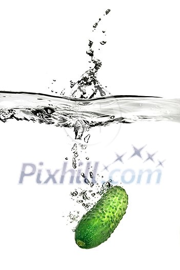 green cucumber dropped into water isolated on white