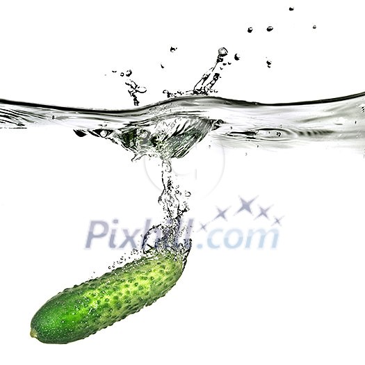 green cucumber dropped into water isolated on white