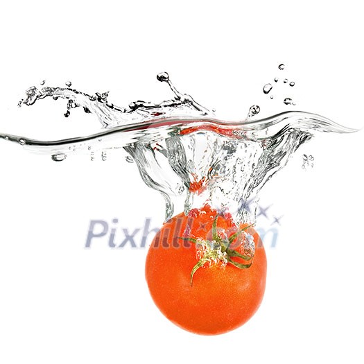 red tomato dropped into water isolated on white