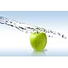 fresh water splash on green apple isolated on white