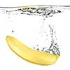 banana dropped into water isolated on white