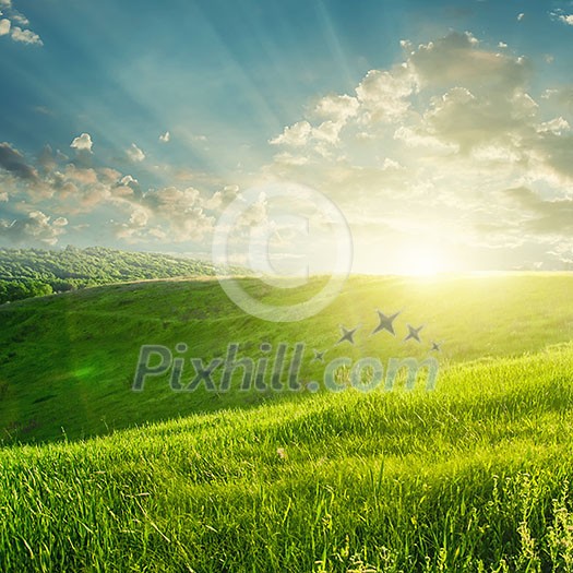 summer landscape on sunset with green field and buautiful clouds